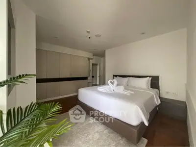 Spacious bedroom with elegant decor and ample closet space, perfect for relaxation and comfort.