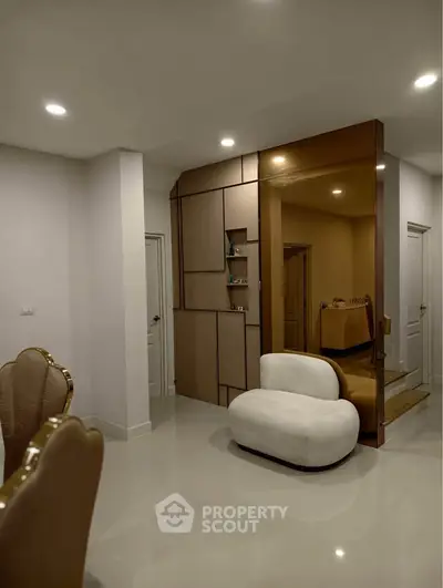 Modern living room with stylish furniture and elegant lighting, showcasing contemporary interior design.
