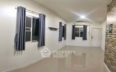 Spacious empty room with tiled floor and modern windows, perfect for customization.