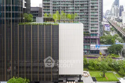 Modern urban building with rooftop garden and city view