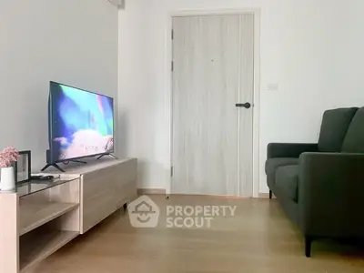 Modern living room with sleek furniture and flat-screen TV, perfect for cozy relaxation.