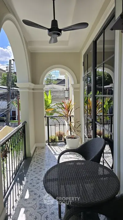 Charming balcony with elegant wrought iron railing and stylish outdoor seating.