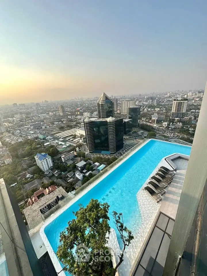Stunning rooftop pool with panoramic city views at sunset, perfect for luxury urban living.
