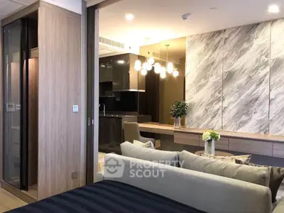 Modern open-plan living room with stylish kitchen and elegant lighting