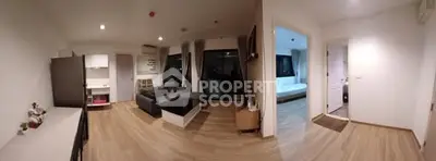 Spacious modern apartment with open living room and bedroom layout, featuring sleek wooden flooring.