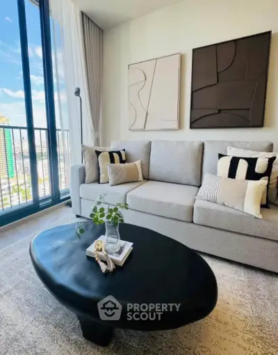 Modern living room with stylish decor and city view from large windows.