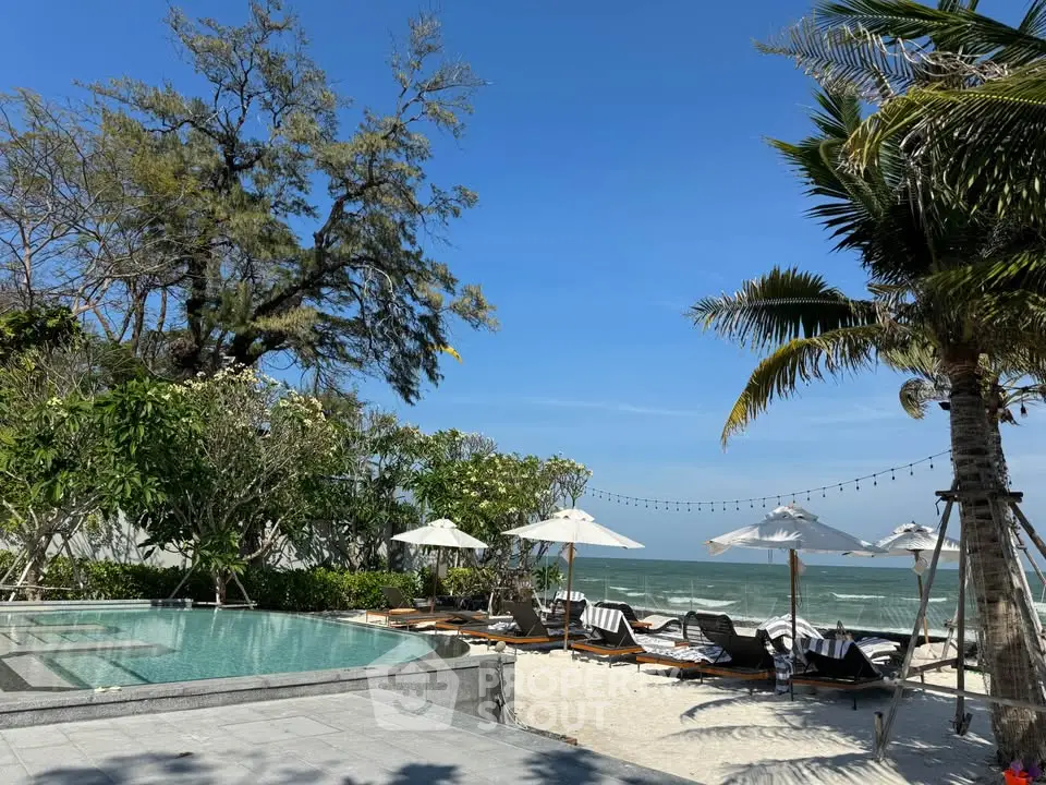 Luxurious beachfront property with pool and ocean view, perfect for relaxation and leisure.