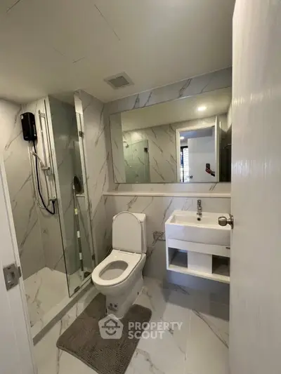 Modern bathroom with sleek shower and elegant marble tiles