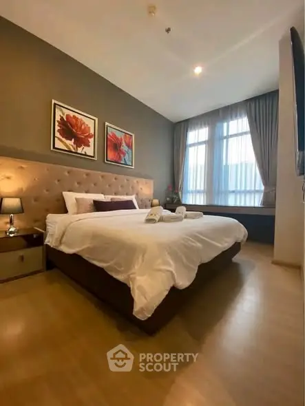 Luxurious bedroom with elegant decor and large window for natural light.