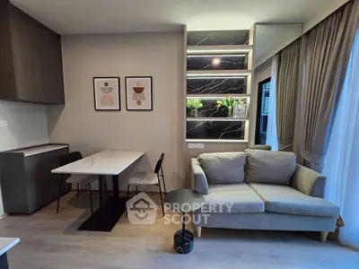 Modern living room with stylish decor, cozy sofa, and elegant dining area in a contemporary apartment.