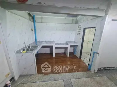 Spacious kitchen with dual sinks and tiled countertops in a modern home.