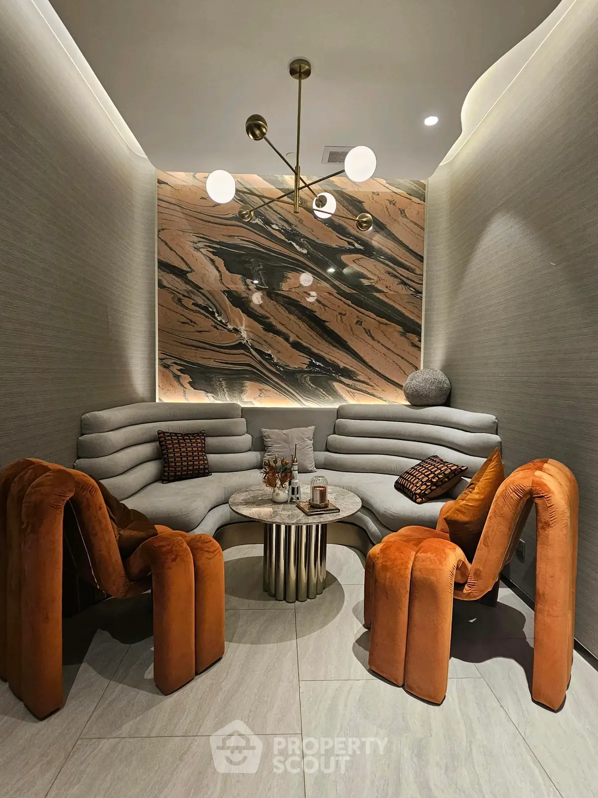Luxurious modern living room with unique orange chairs and elegant lighting