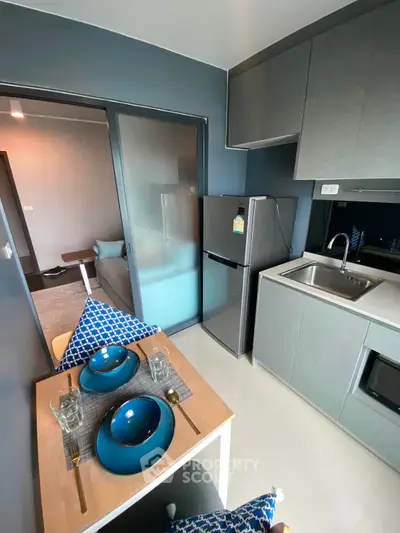 Modern compact kitchen with sleek appliances and dining area in stylish apartment