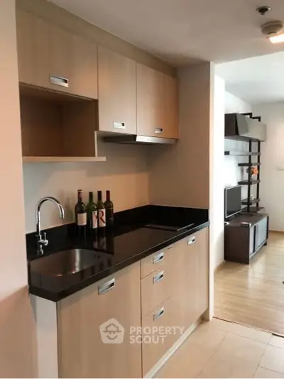 Modern kitchen with sleek cabinetry and open layout in stylish apartment