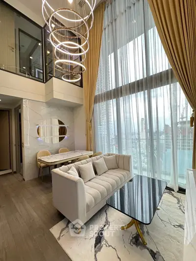 Luxurious modern living room with high ceilings and elegant decor in a stylish apartment.