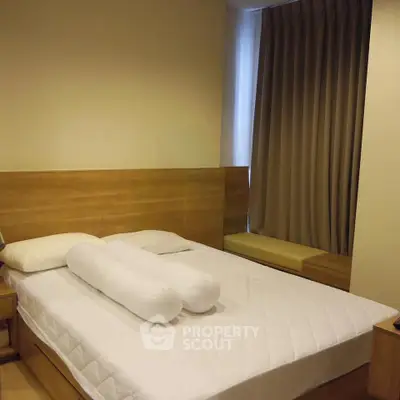 Cozy bedroom with modern wooden furniture and soft lighting, perfect for relaxation.