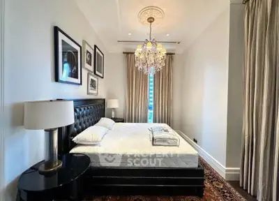 Luxurious bedroom with elegant chandelier and stylish decor