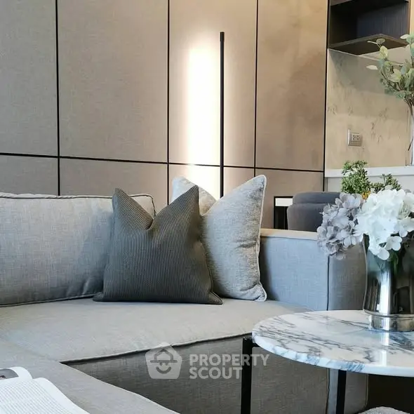 Modern living room with stylish gray sofa and marble coffee table