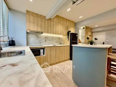 Modern kitchen with wooden cabinets and marble countertops in stylish apartment