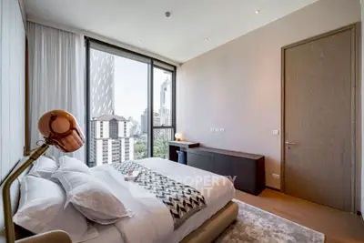 Luxurious bedroom with stunning city view in modern high-rise apartment.