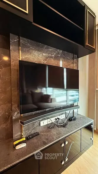 Modern living room with sleek TV setup and marble accents