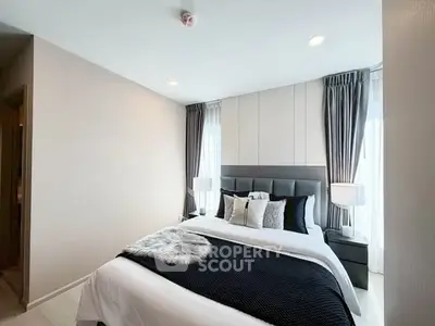 Elegant bedroom with modern decor and ample natural light