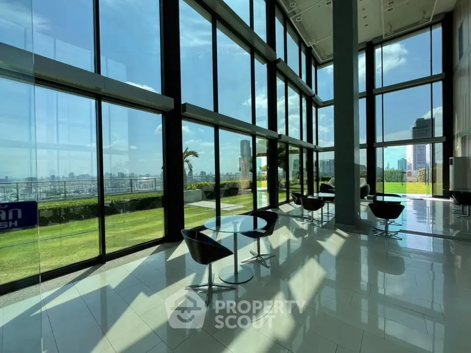 Stunning modern building lobby with floor-to-ceiling windows and cityscape views.