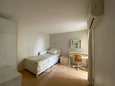 Cozy bedroom with single bed, desk, and air conditioning in minimalist style.