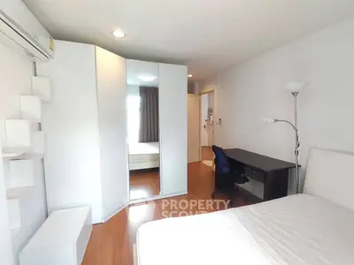 Spacious bedroom with modern furniture and ample natural light