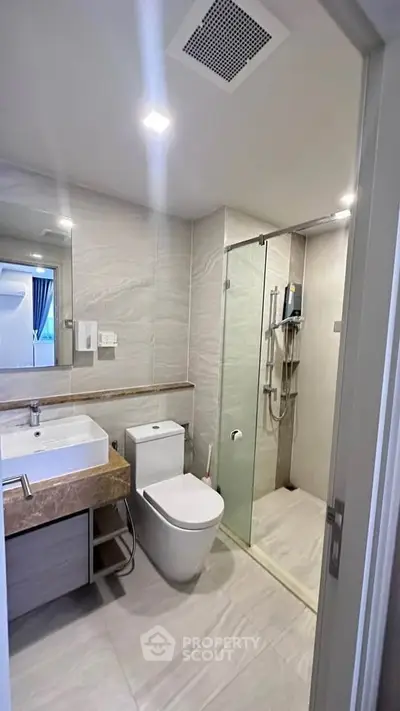 Modern bathroom with glass shower and sleek fixtures