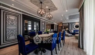 Luxurious dining and living area with elegant decor and modern lighting in a spacious open layout.