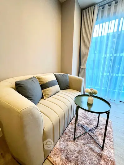 Cozy living room with modern sofa and stylish decor, perfect for relaxation.