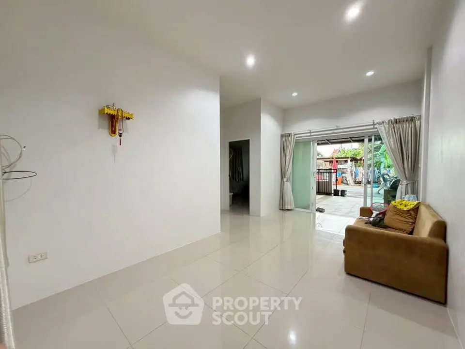 Spacious living room with modern design and garden view, perfect for family gatherings.