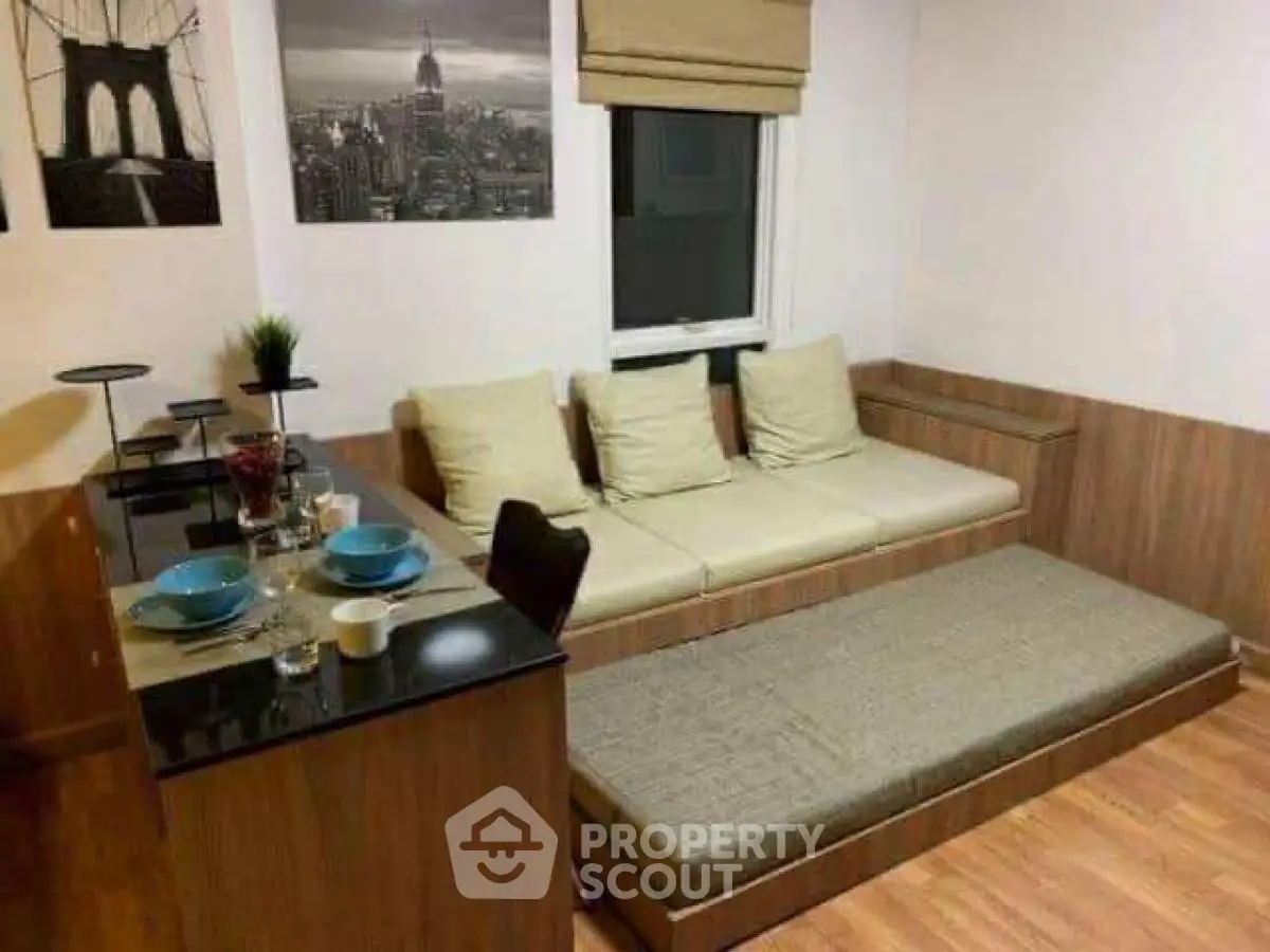 Modern living room with stylish sofa and dining area, featuring elegant decor and cozy ambiance.