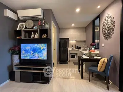 Modern open-plan living room and kitchen with stylish decor and appliances