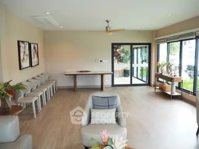 Spacious modern living room with elegant decor and large windows for natural light.