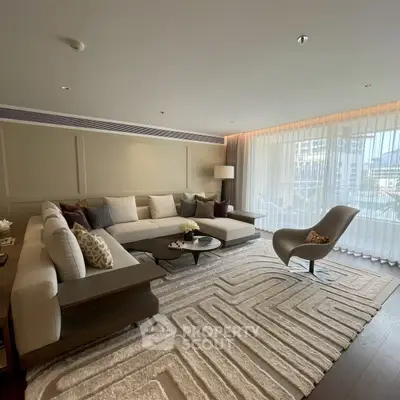 Luxurious living room with modern decor and large windows offering natural light.