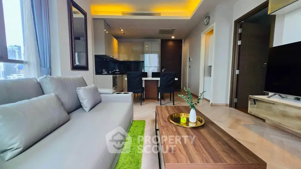 Modern living room with open kitchen, stylish decor, and city view, perfect for urban living.