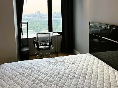Modern bedroom with city view and sleek furnishings
