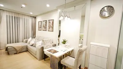 Elegant living room with plush sofa, chic decor, and ambient lighting in modern apartment.