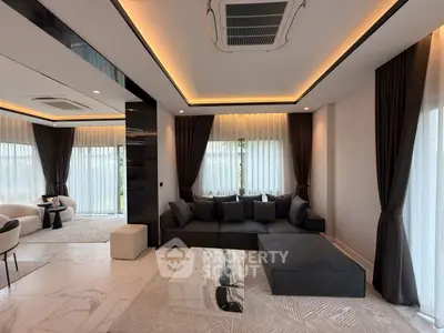 Luxurious modern living room with elegant decor and large windows