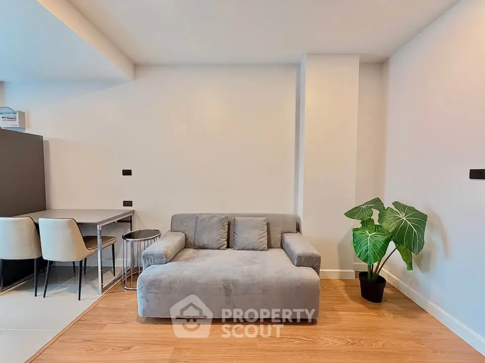 Modern living room with stylish gray sofa and elegant workspace