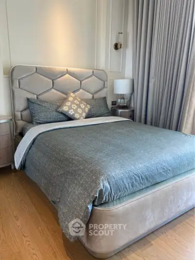 Luxurious bedroom with elegant decor and plush bedding in a modern apartment.