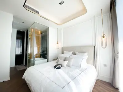 Luxurious modern bedroom with elegant lighting and glass-enclosed bathroom