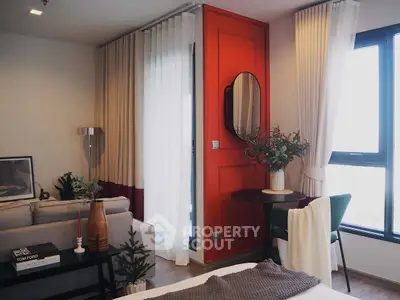 Stylish modern living room with vibrant red accent wall and cozy decor