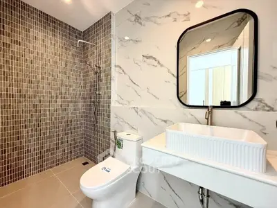 Modern bathroom with elegant marble walls and stylish fixtures