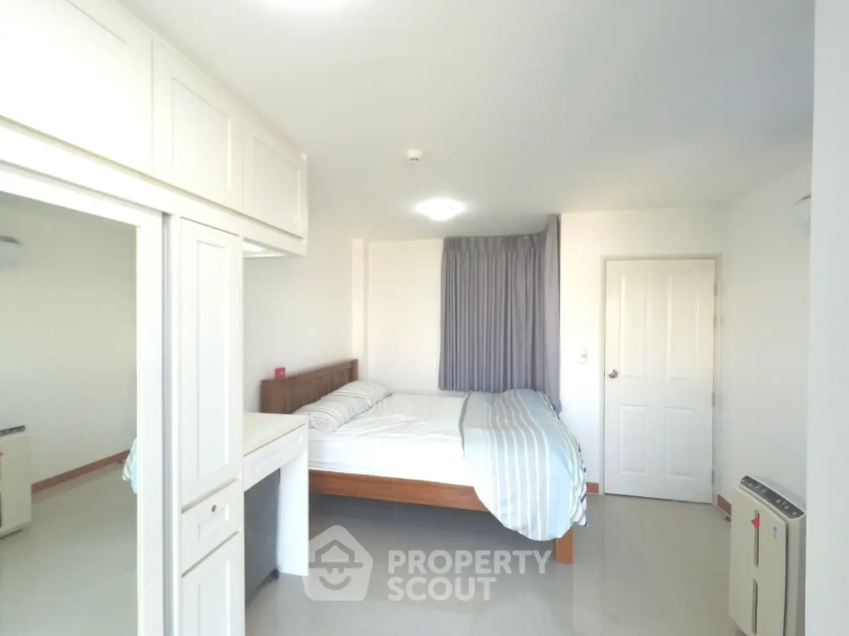 Bright and spacious bedroom with modern furnishings and ample natural light