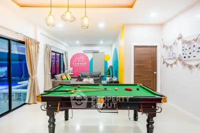 Stylish living room with pool table and modern decor in vibrant colors.