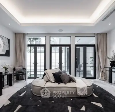 Luxurious modern living room with elegant decor and large windows for natural light.