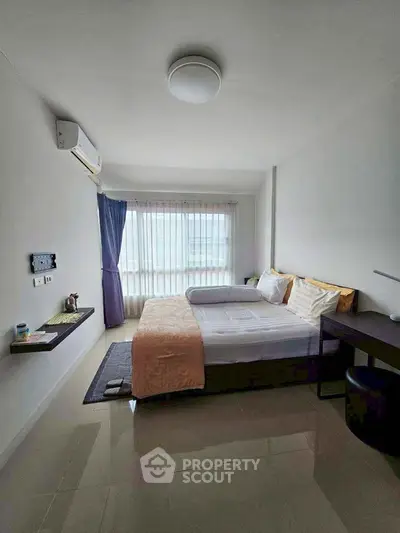 Cozy bedroom with modern decor and large window for natural light